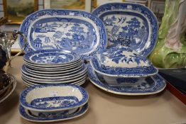 A good selection of early cream ware blue and white willow wares plates dishes and two chargers