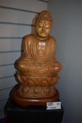 A hand carved wooden Tibbetan Buddha statue on lotus leaf base approx 55cm tall