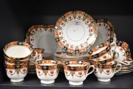 A selection of early 20th century English plates,cups and saucers having hand tinted transfer