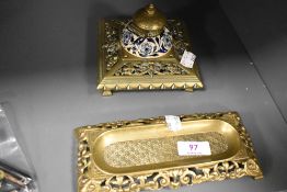 A decorative brass Victorian ink well with blue and white ceramic liner and a similar desk tidy.