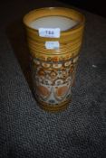 A mid century Minaret vase by Denby being hand decorated