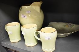 A 1930's green glazed Crown Devon triangular bowl, decorated with flowers and sold together with a