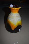 A mid century vase by West German pottery marked Bay 66 20 in a fat lava orange and yellow glaze
