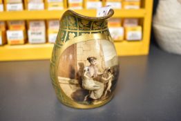 A small porcelain beaker being hand decorated with scene of a cherub signed A Dagoty Paris (handle