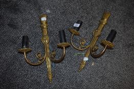 A pair of brass wall mounted lights having twin branch arms