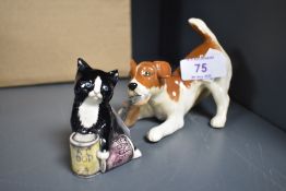 A Beswick terrier puppy with slipper and a Royal Doulton cat with tins of cat food.