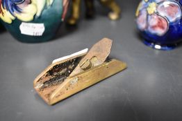 An early 20th century miniature brass hand plane.