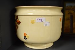 A 1930's Myott, Son & Co jardinaire, moulded and hand-painted in earthy tones with foliage