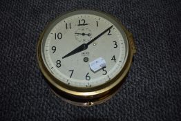 A ships style port hole design clock by Smiths Empire having brass case
