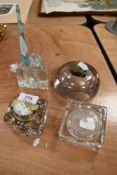 Four glass ink wells including two brass topped and one having glass lid