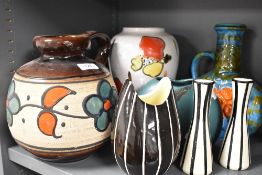 A mid century West German handles vase or flagon, with vibrant floral decoration, sold along with