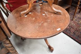 A 19th Century circular tripod table , converted to coffee table, having turned column and elegant