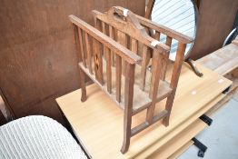 An Arts and Crafts oak canterbury magazine stand