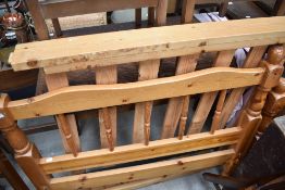 A modern single bed frame, in pine