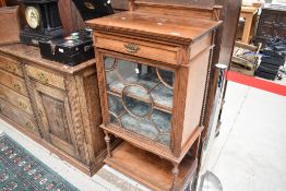 A late Victorian mahogany bijouterie cabinet, having frieze drawer and velvet lined glazed cabinet ,