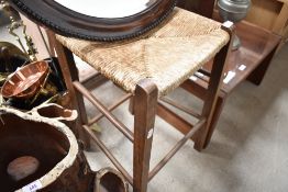 A stained frame and seagrass kitchen stool