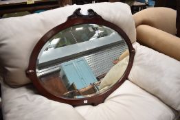 A Victorian mahogany wall mirror having shaped frame
