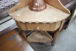 A modern pine corner washstand, of traditional design with single drawer and under tier