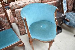 An Edwardian tub style corner seat having cabriole legs and teal upholstery