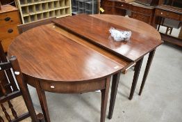 A 19th Century mahogany D end banquetting table having three centre leaves