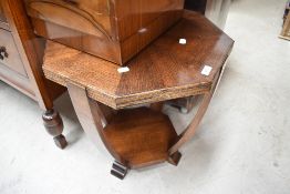 An early 20th Century oak octagonal occasional table having shaped base