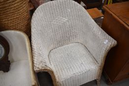A Lloyd Loom 'lusty' woven wicker tub armchair, white and gilt painted.
