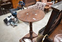 A 19th century mahogany pedestal wine table, having a circular one piece top above the turned column
