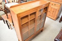 A modern golden oak display cabinet