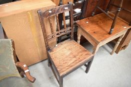 A 19th Century stained frame dining chair having solid seat