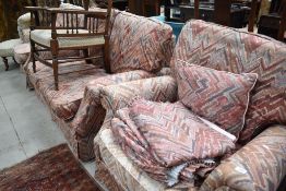 A vintage three piece suite comprising settee, chairs and pair of matching curtains