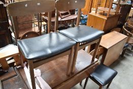 A traditional oak drop leaf dining table on tapered legs