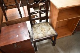 An early 20th Century stained frame rail back dining chair