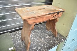 A traditional stool having solid splay legs