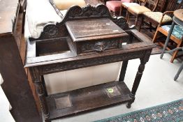 A late 19th or early 20th Century carved oak hall stand