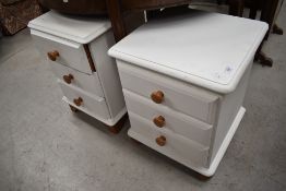 Two modern white painted pine bedside chests, with turned pine knob handles, bracket and bun feet.