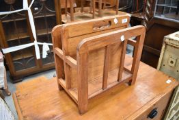 A modern mahogany magazine rack, with two divisions and central carrying handle