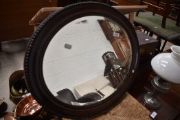 An oval wall mirror