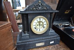 A Victorian black slate mantel clock, manufactured by The Ansonia clock company