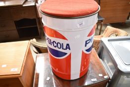 A Pepsi Cola branded stool, contains roll of Pepsi barrier or wrapping style tape