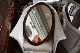 A modern mahogany shaped wall mirror