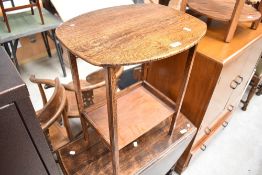 An early 20th Century oak occasional table with undershelf
