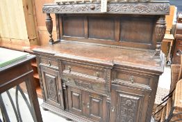 A Late Victorian sideboard in the court cupboard style having carved and pokerwork decoration, width