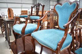 Two 20th century salon chairs having teal blue upholstery both with carved and shaped backs
