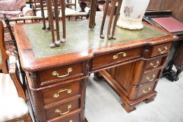 A good reproduction mahogany twin pedestal desk, the rounded rectangular inverted break-front top