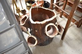 A reconstituted garden planter, in the form of a log