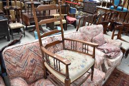 An Edwardian ladder back arm chair with wool work seat