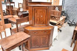 An Edwardian mahogany two part corner cupboard having line inlay decoration