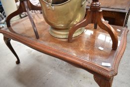 A reproduction mahogany coffee table with glass inset top, cabriole type legs