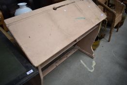 A traditional painted double school desk having adjustable top, width approx. 102cm