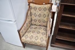 An Edwardian mahogany and inlaid easy chair, heavy frame and later upholstery